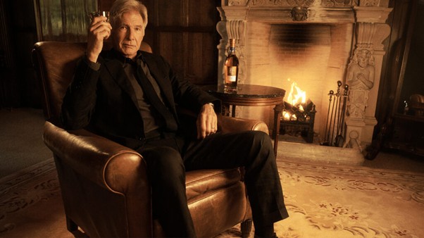 Harrison Ford sits by the fireplace in a recent Glenmorangie ad campaign
